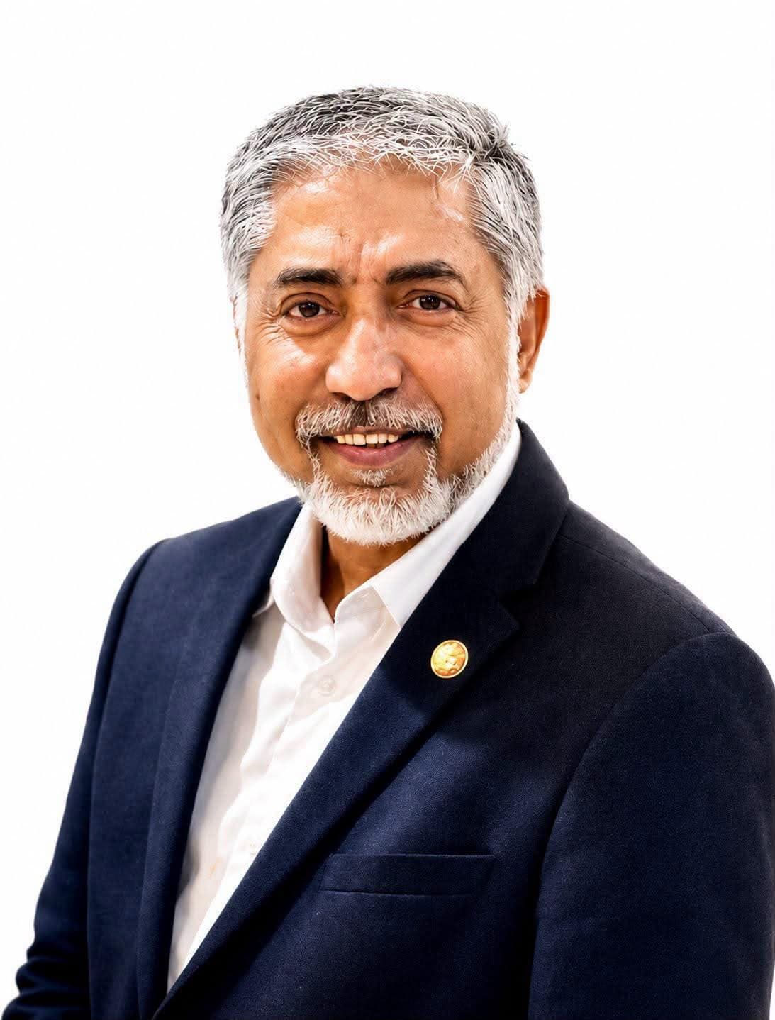 Portrait of Mizanur Rahman Mizan in a navy blazer