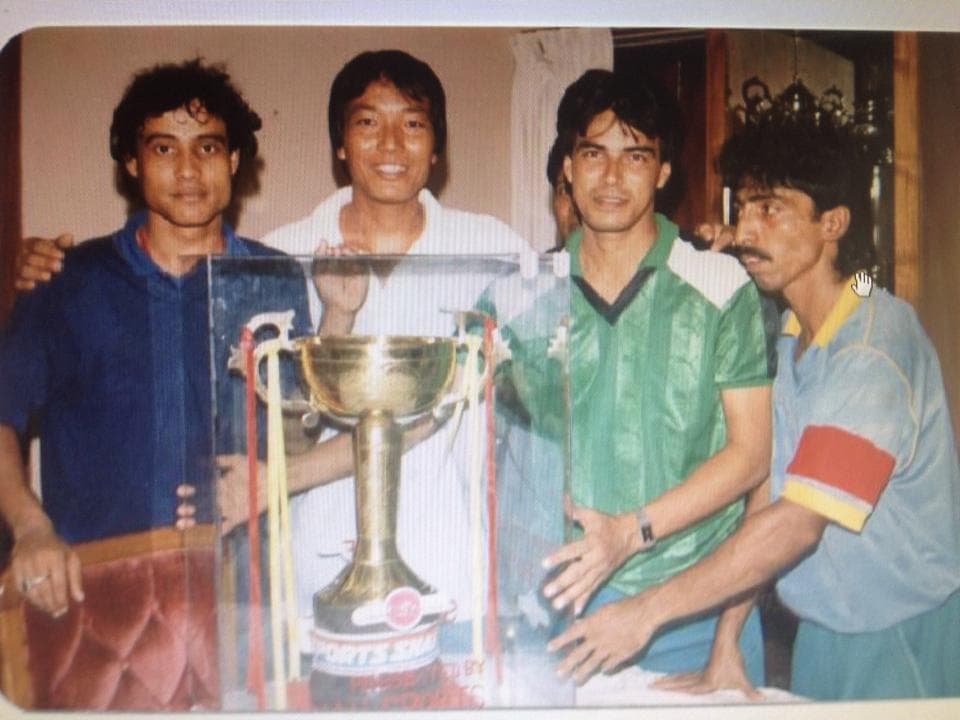 Mizanur Rahman Mizan celebrating with team mates and a trophy